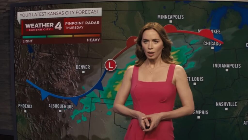 Emily Blunt reporting weather news in Disclosure Day movie
